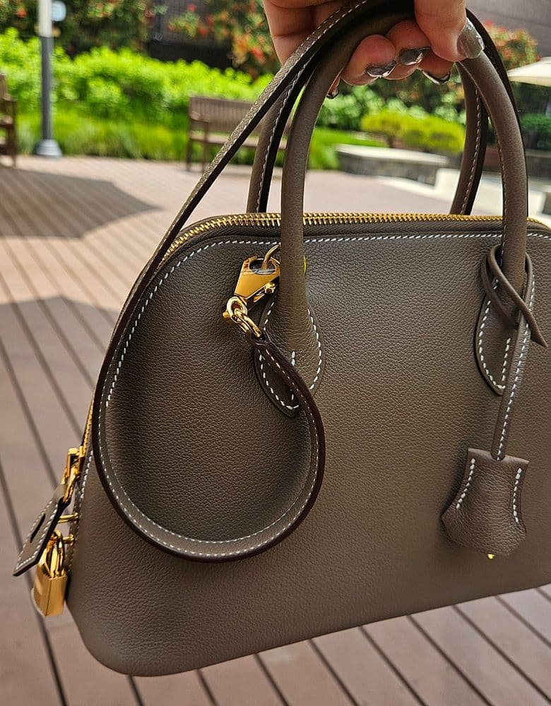 Bulgari Seduttori watch, Serpenti ring, Hermès loafers, Finesse, Bolide 25 Etoupe. Prada briefcase.