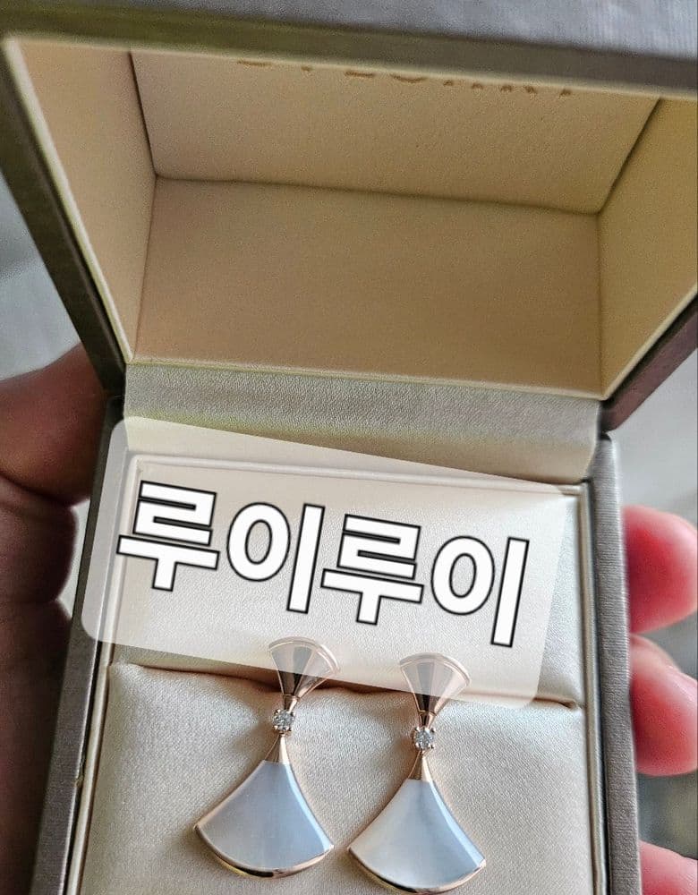 Bulgari Divas' Dream Earrings with a milky, opalescent mother-of-pearl.