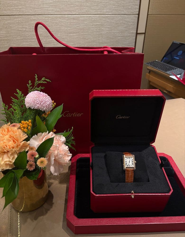 Cartier Tank Louis with a brown strap.