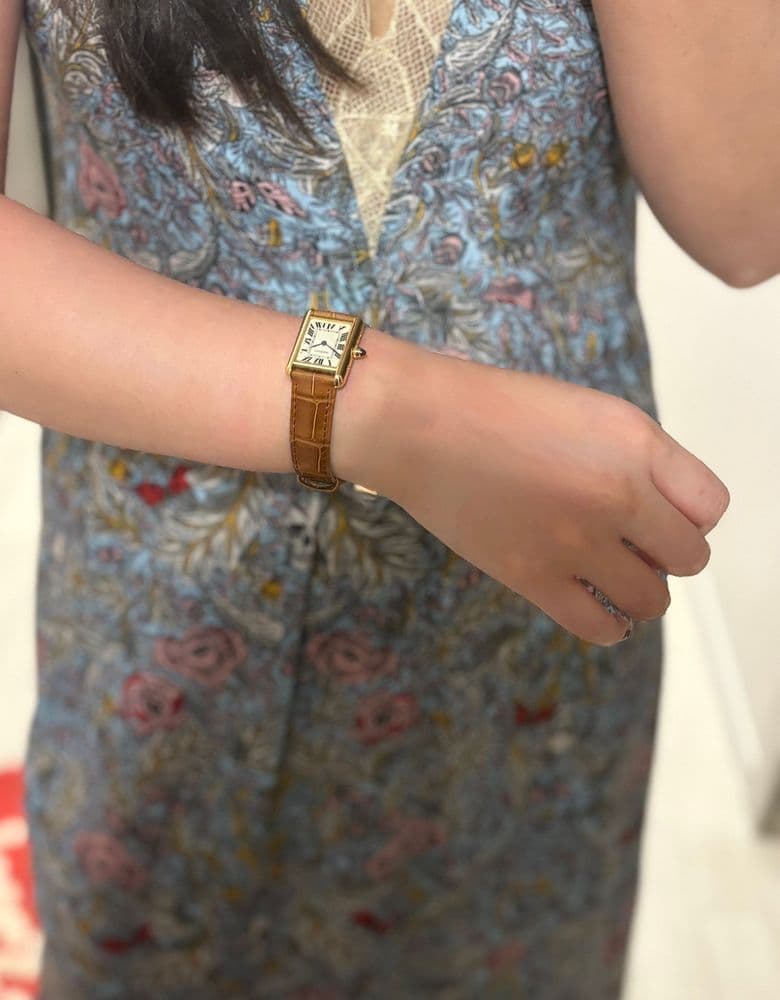 Cartier Tank Louis with a brown strap.