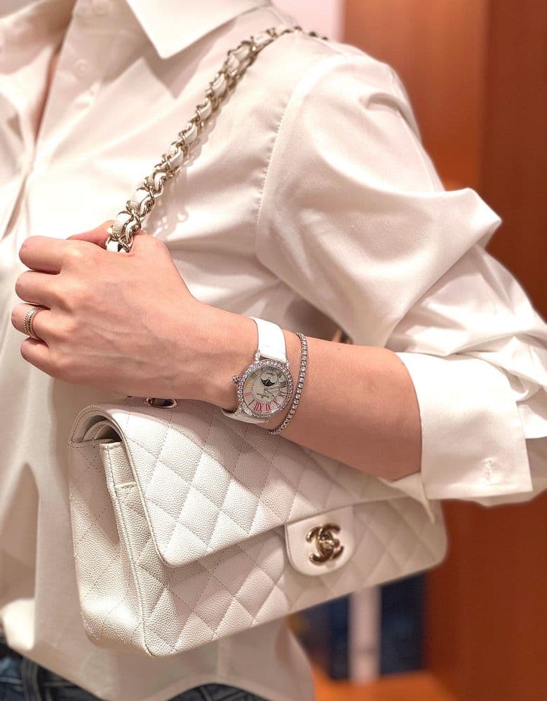 Looking for a Chanel Classic Flap Bag in white, perhaps a 22 Bag (large size), a vintage flap bag, or a Coco Handle in small.