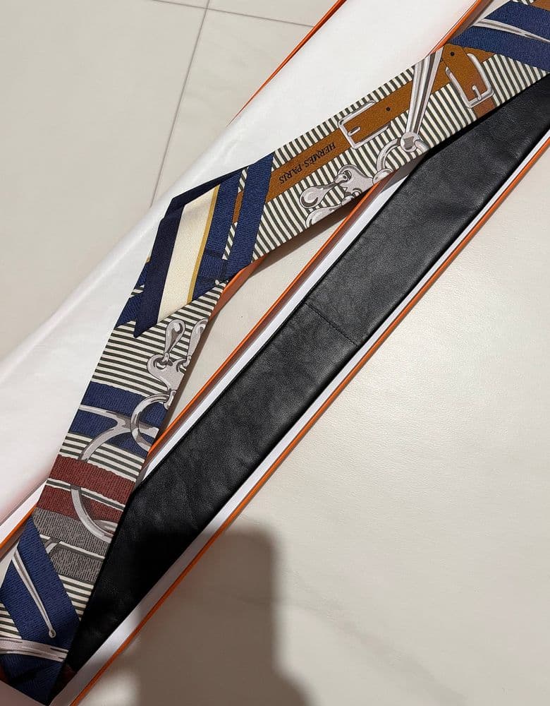 Hermès Twilly scarf in a longer, leather version.